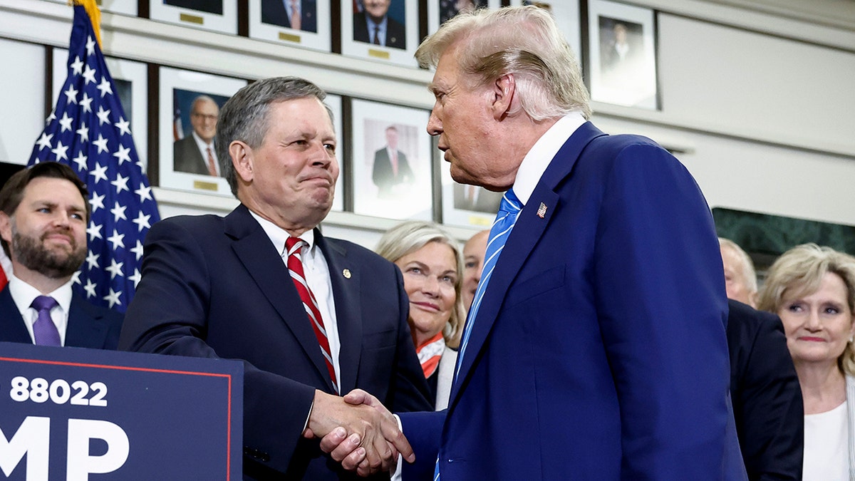Sen. Steve Daines shaking hands with Trump