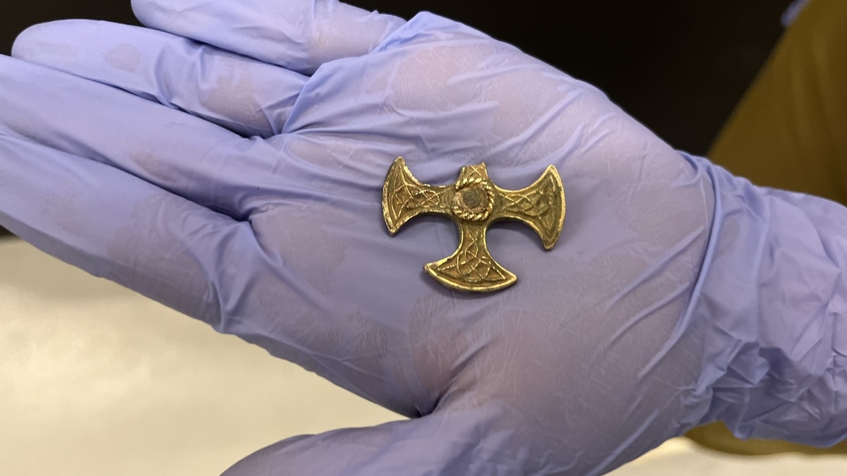 hand holding Saxon pendant