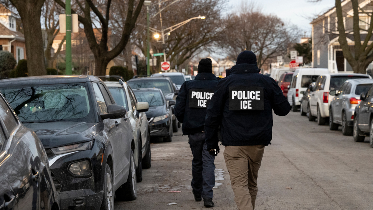 ICE officers walking down street