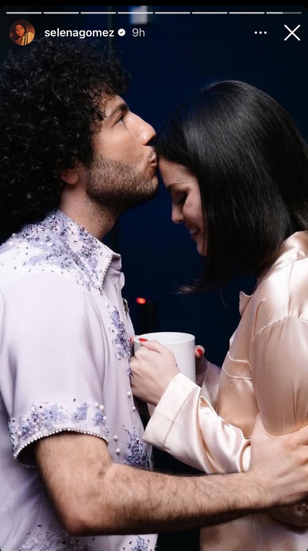 two individuals interacting closely one holding a mug