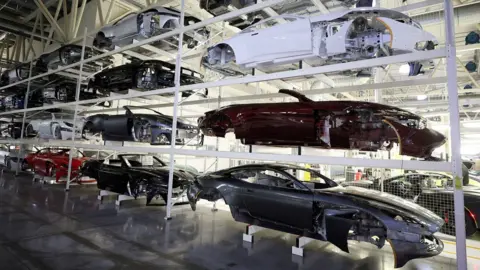 Reuters Car bodies are stored on shelves at the Aston Martin factory in Gaydon, Britain