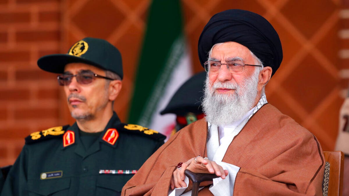 In this picture released by an official website of the office of the Iranian supreme leader, Supreme Leader Ayatollah Ali Khamenei, right, reviews armed forces. (Office of the Iranian Supreme Leader via AP)