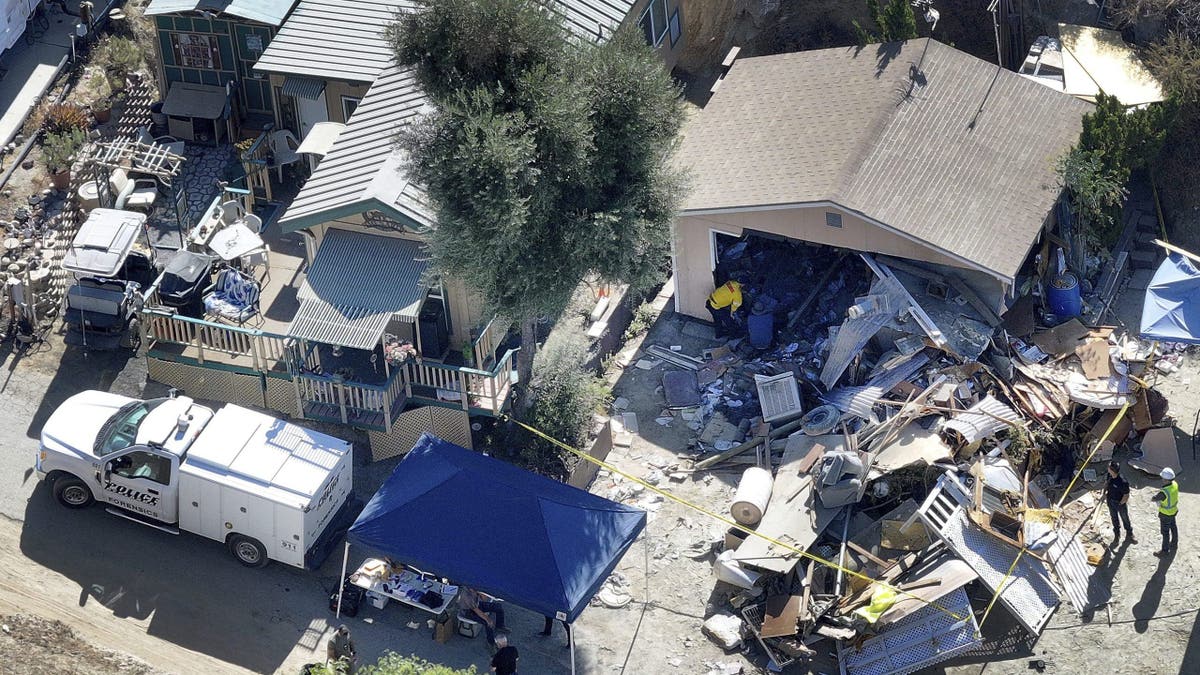An aerial view above the Olive Dell Ranch nudist resort showing the toppled home of murder suspect Michael Sparks after a police raid