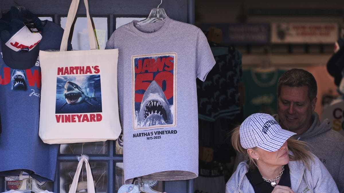 A shopper walks past items featuring the "Jaws" movie at Neptune's Sea Chest gift shop on May 12, 2025, in Vineyard Haven, Massachusetts, on Martha's Vineyard Island.
