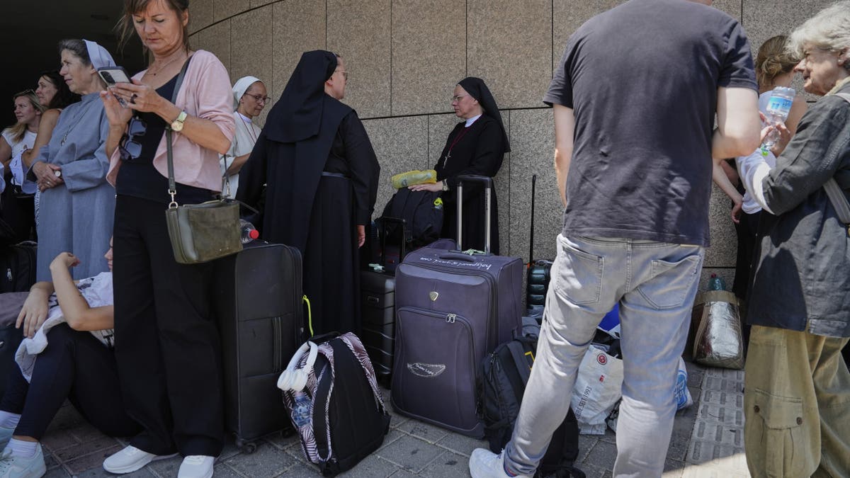 travelers waiting to leave Tel Aviv airport