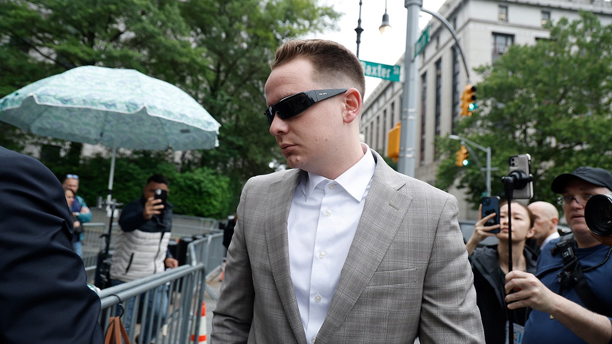 Brendan Paul wears grey suit at court.