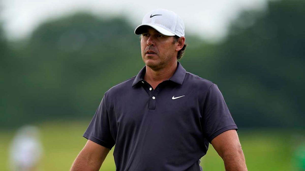 Brooks Koepka looks on