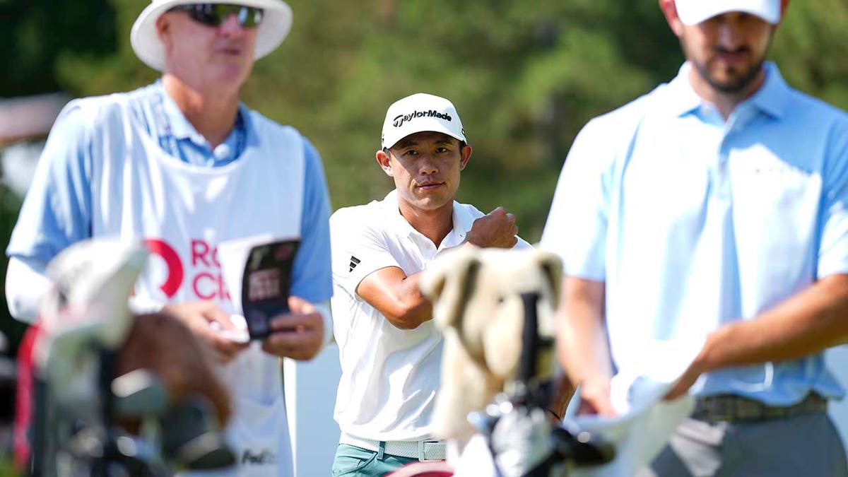 Collin Morikawa looks on