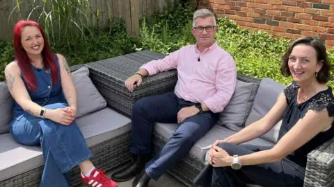 Nic Rigby/BBC Would-be house hunter Lauren Pinch, Spencer Burrell of Big Sky Living - the developer of the estate at Cringleford, and businesswoman CJ Green discussing housing issues as part of BBC Politics East special programme