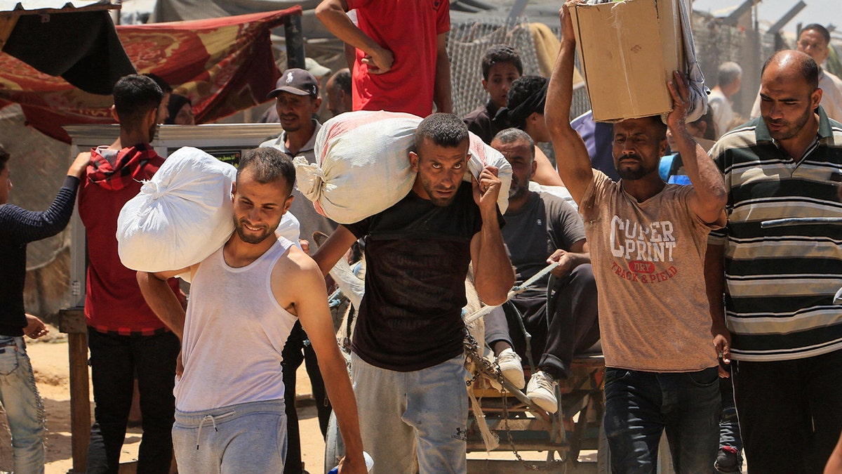 Palestinians carrying humanitarian aid