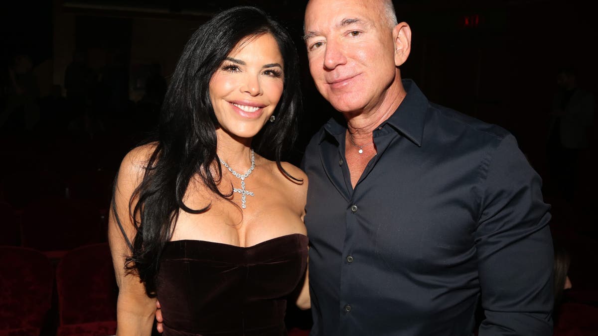Lauren Sanchez and Jeff Bezos smile while posing for a photo