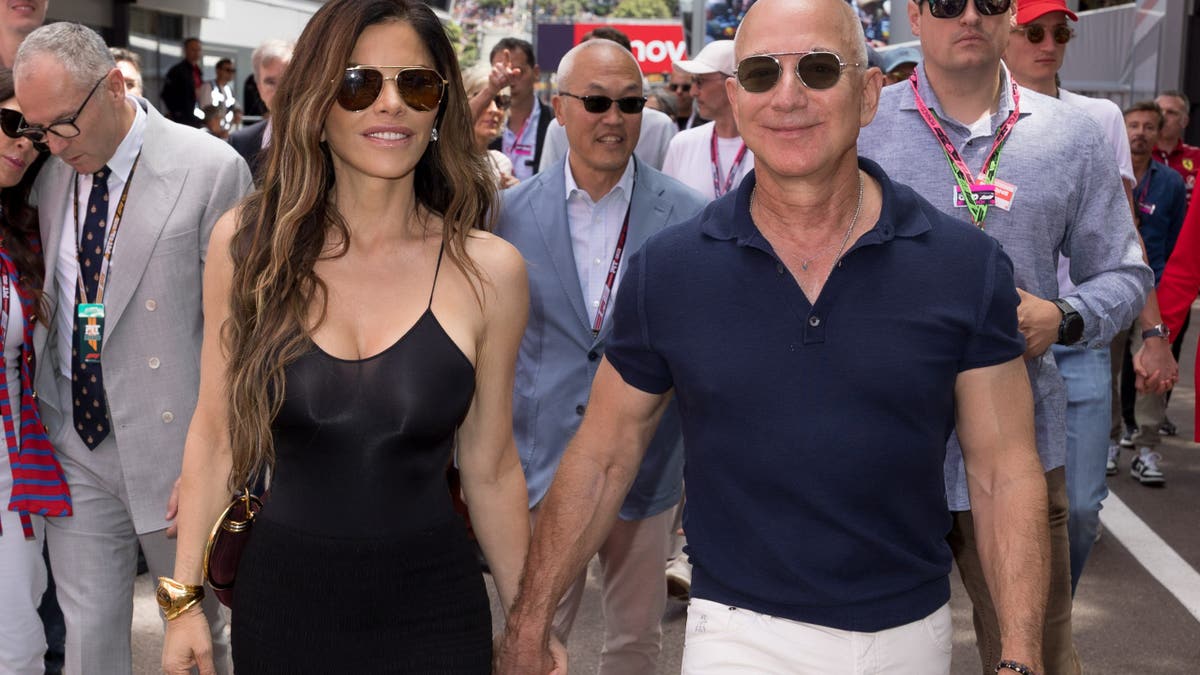Jeff Bezos and Lauren Sanchez walking hand in hand in Monaco