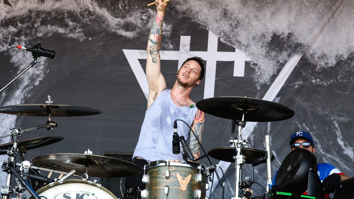 Daniel Williams plays the drums during concert.