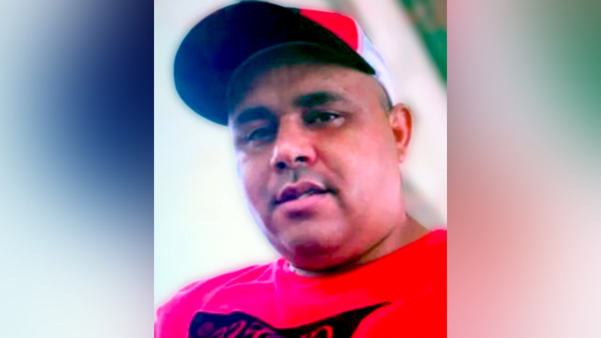 Giovanni Vicente Mosquera Serrano in red shirt and cap