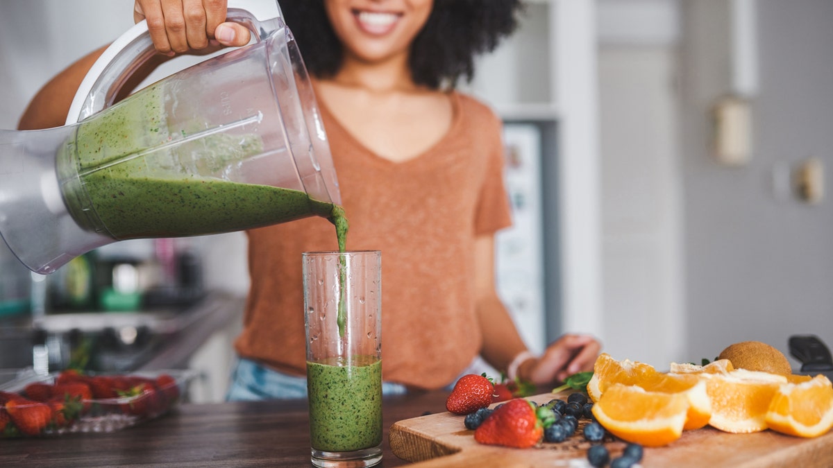 Woman pouring smoothie