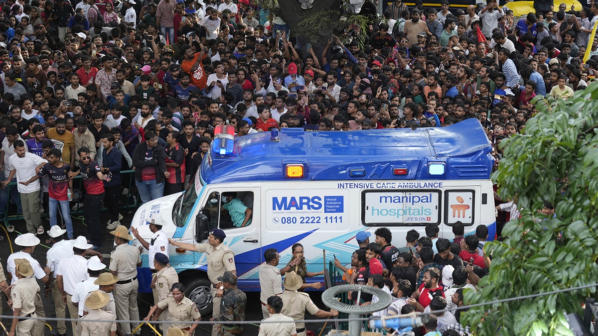 A ambulance stands out in a crowd of people