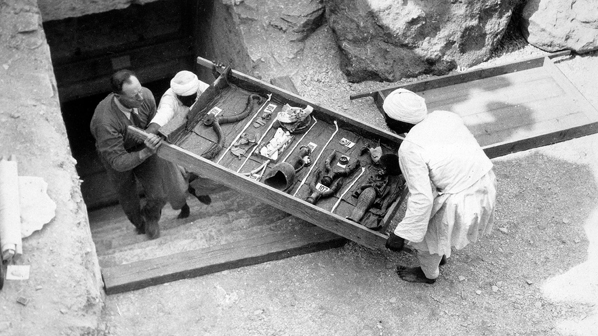 Removing a tray of chariot parts from the Tomb of Tutankhamun, Valley of the Kings, Egypt, 1922.