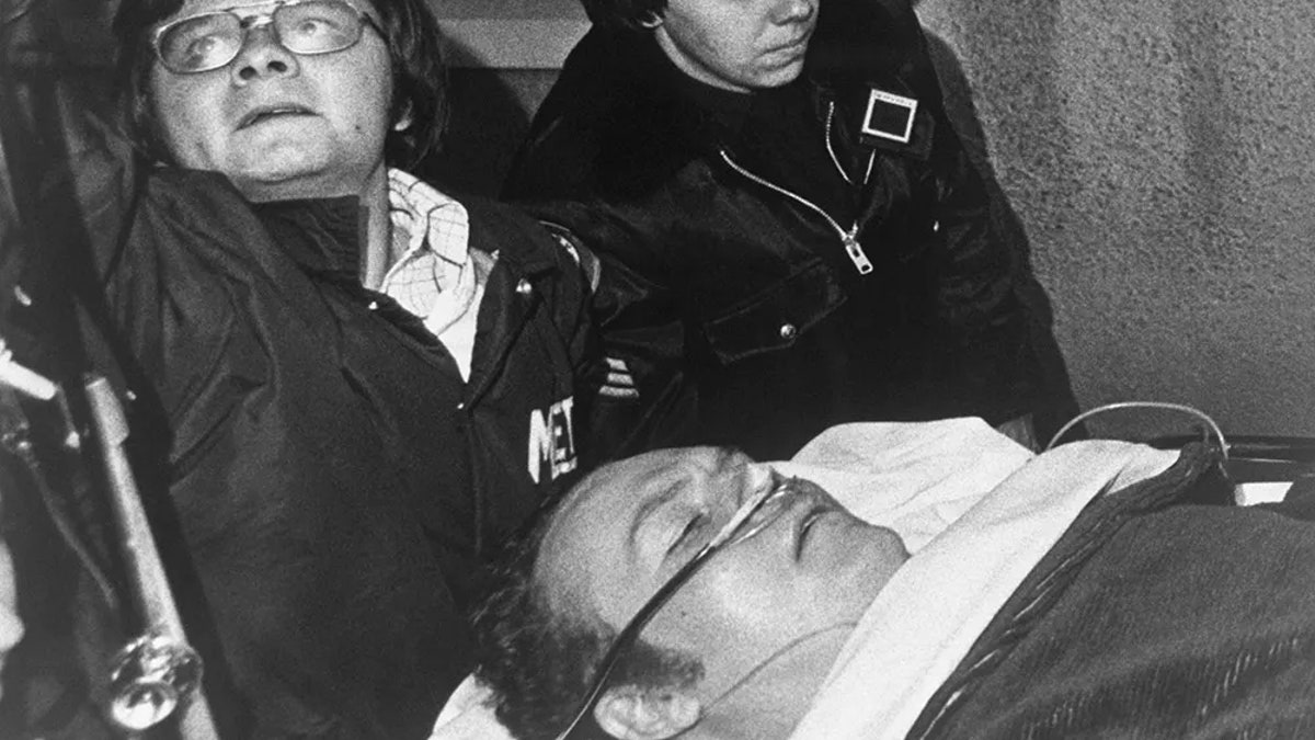 Larry Flynt on a stretcher receiving oxygen.