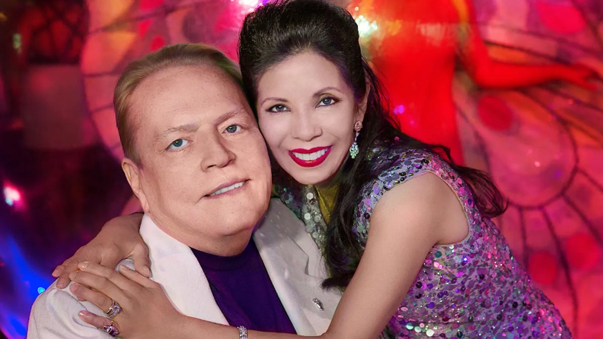 Liz Flynt embracing a smiling Larry Flynt.