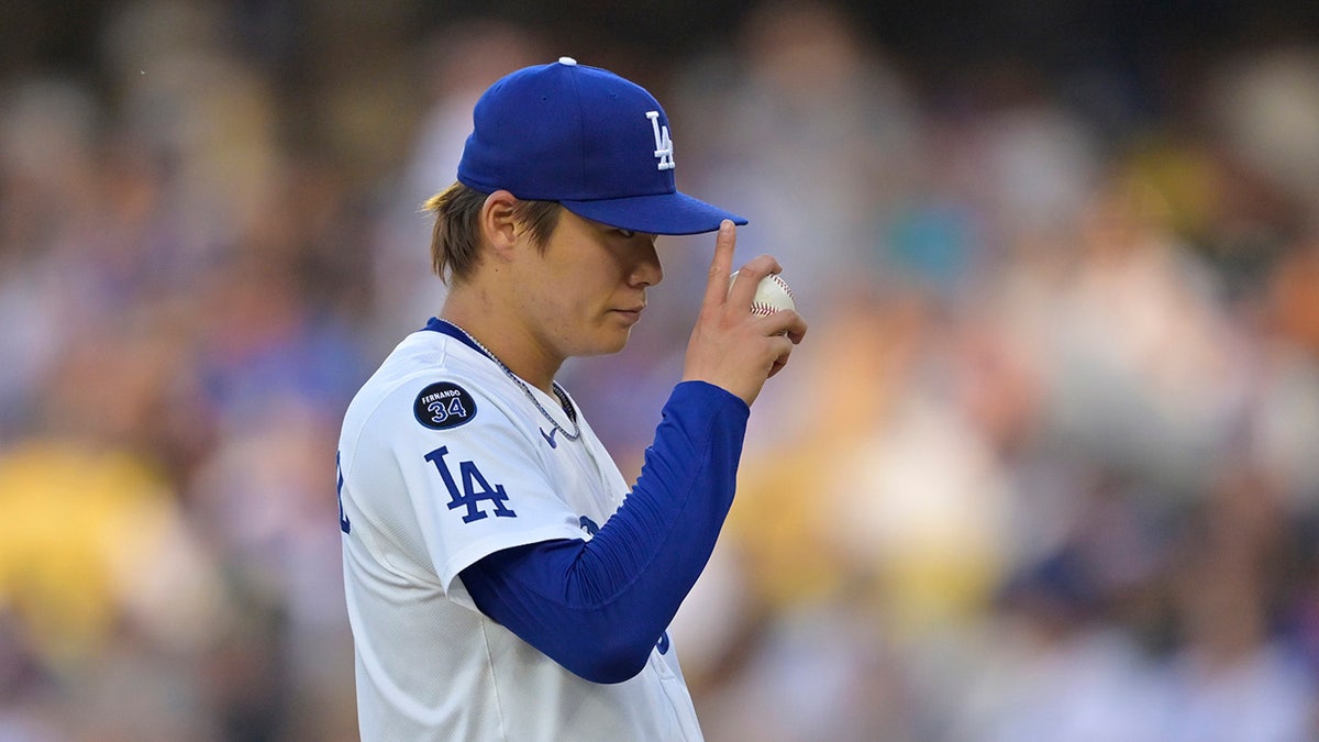 Dodgers pitcher Yoshinobu Yamamoto tips his hat