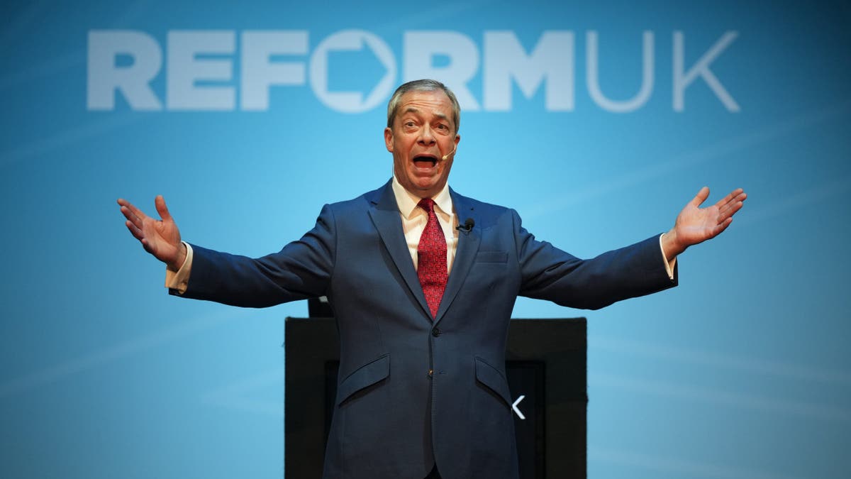 Nigel Farage speaking in front of Reform UK sign