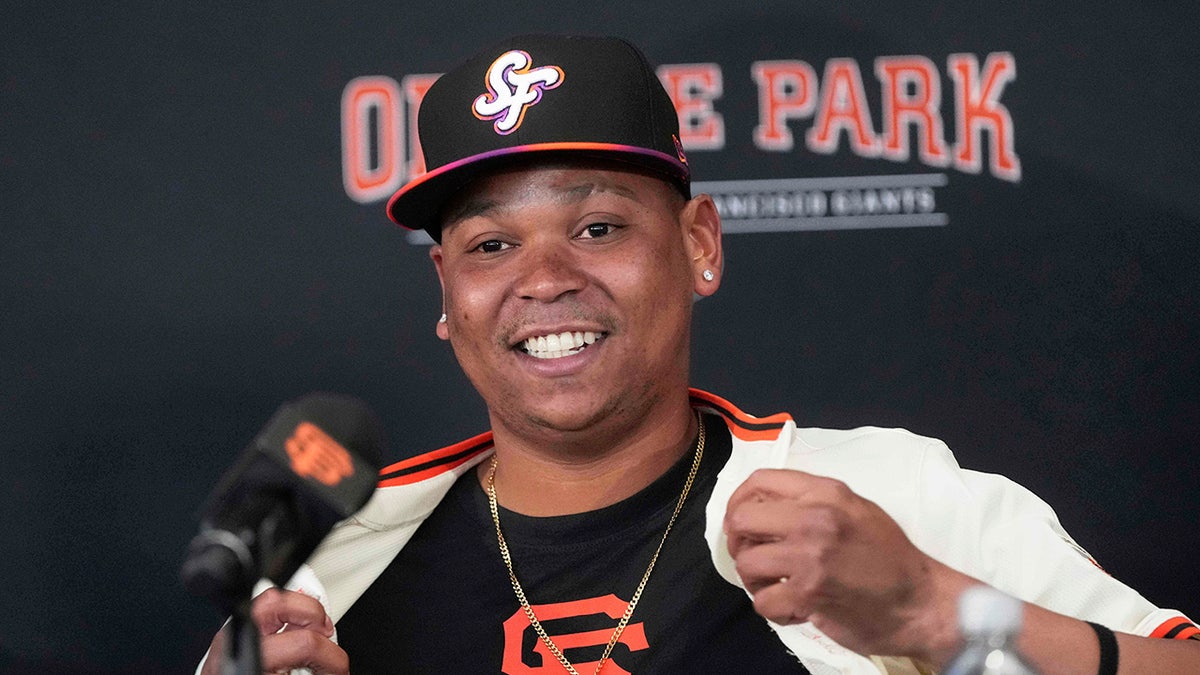 Rafael Devers smiles with Giants jersey