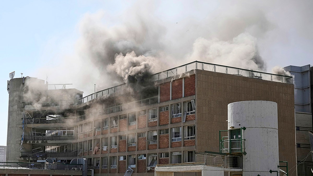 Smokes raises from a building of the Soroka hospital complex after it was hit by a missile fired from Iran in Be'er Sheva, Israel, Thursday, June 19, 2025. (AP Photo/Leo Correa)