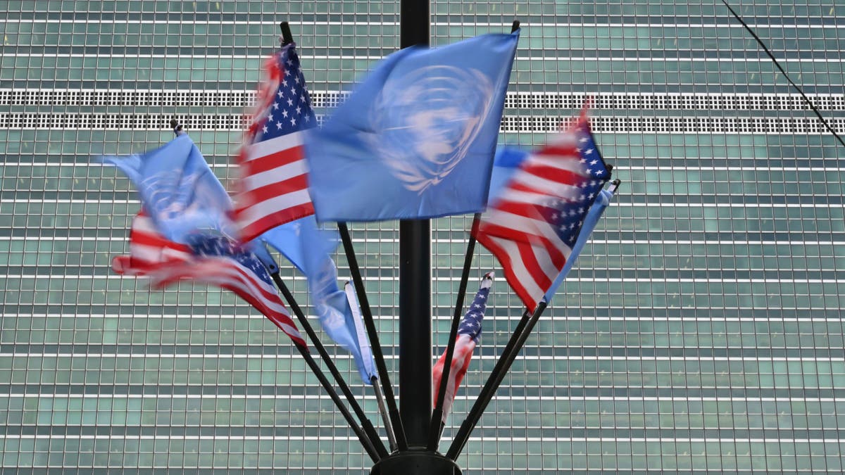 US and UN flags in front of the world body in New York.