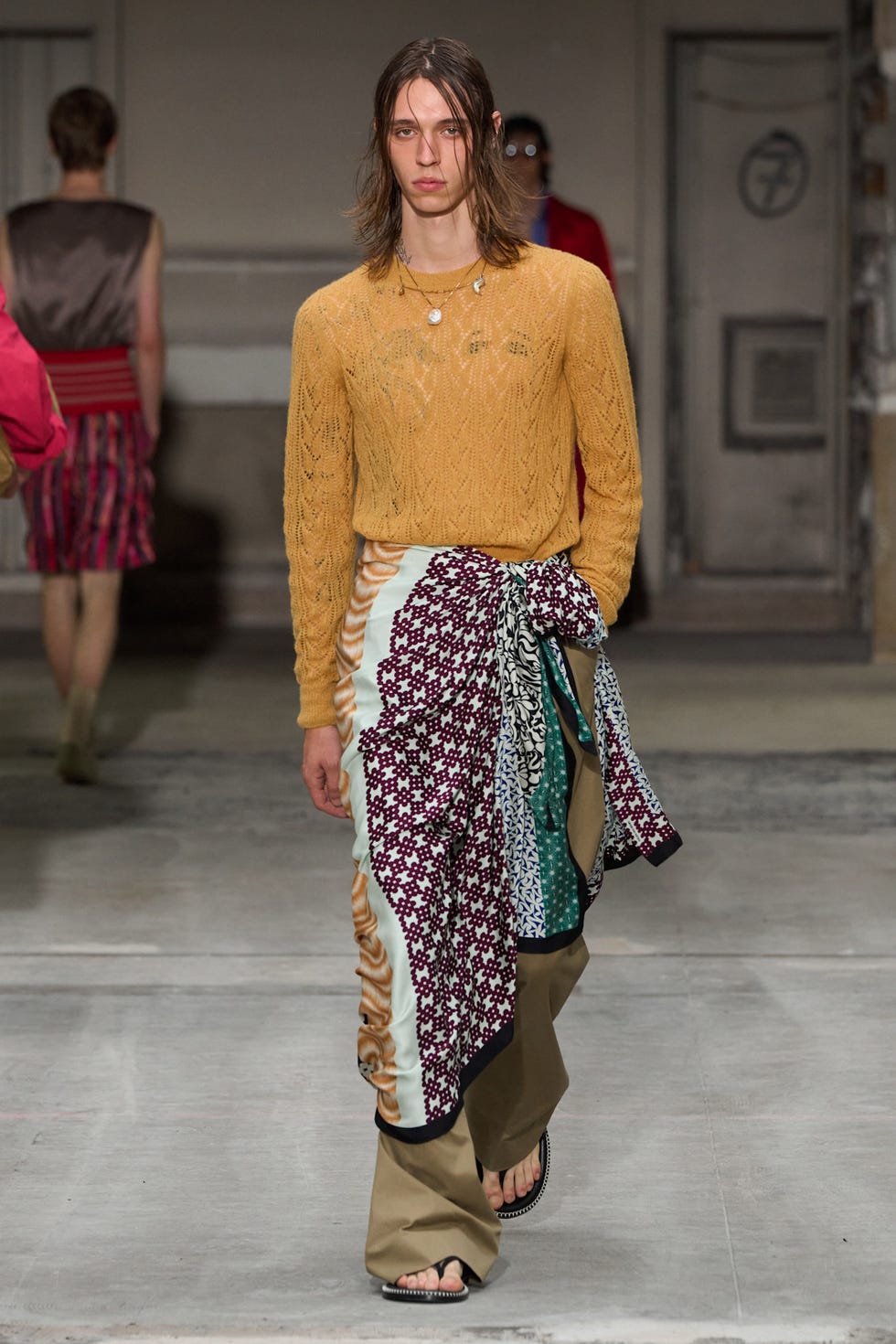 A model showcasing a unique outfit during a fashion show