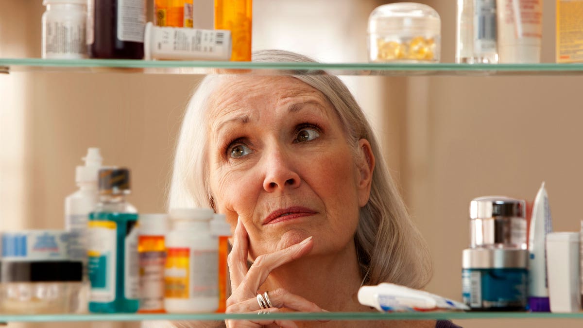 Woman at medicine cabinet