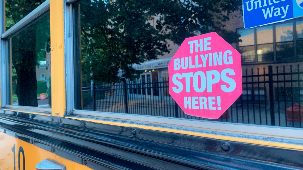 School Bus with a no bullying poster in the window