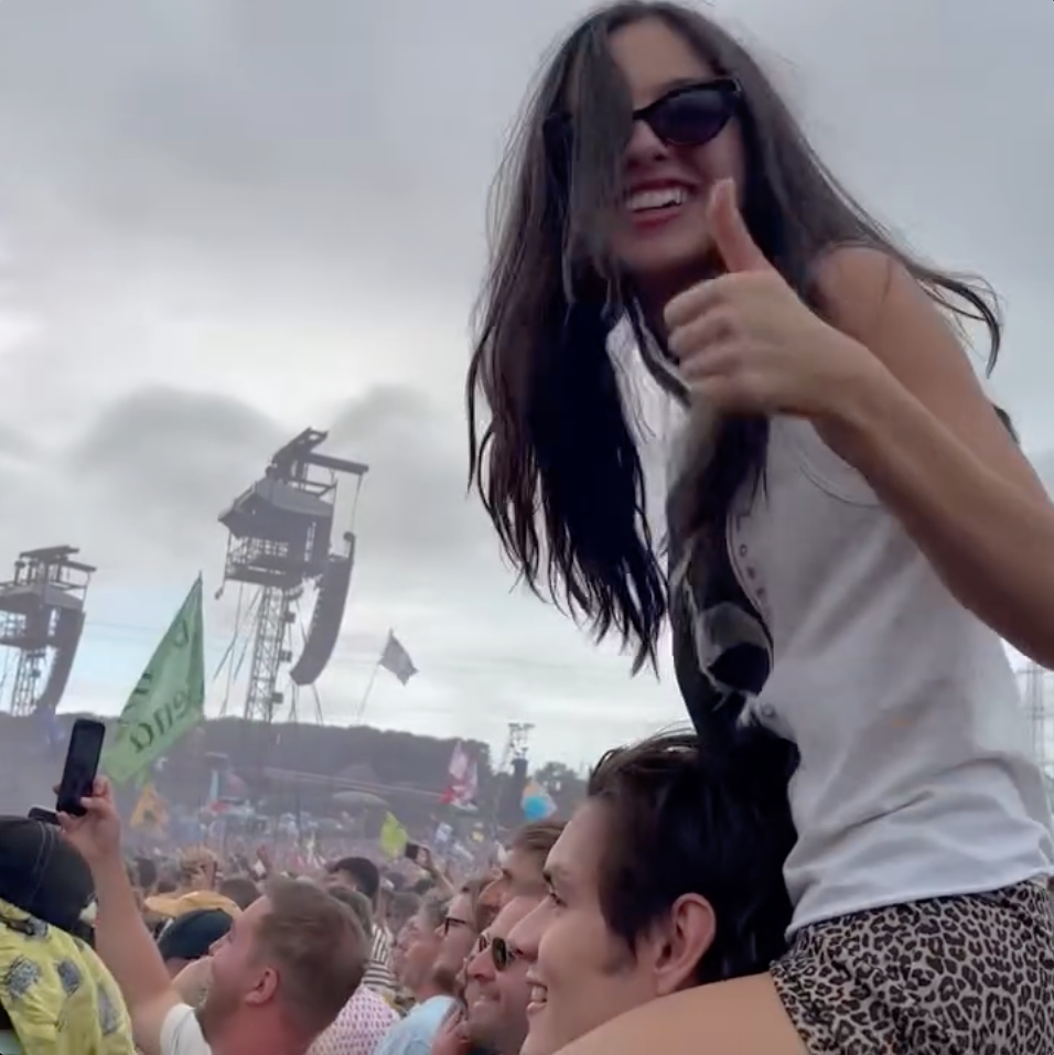 olivia rodrigo on louis partridge's shoulders during glastonbury