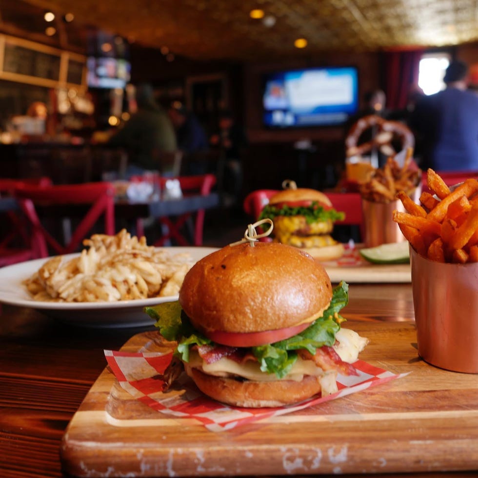 gourmet burgers with fries and sweet potato fries in a casual dining setting