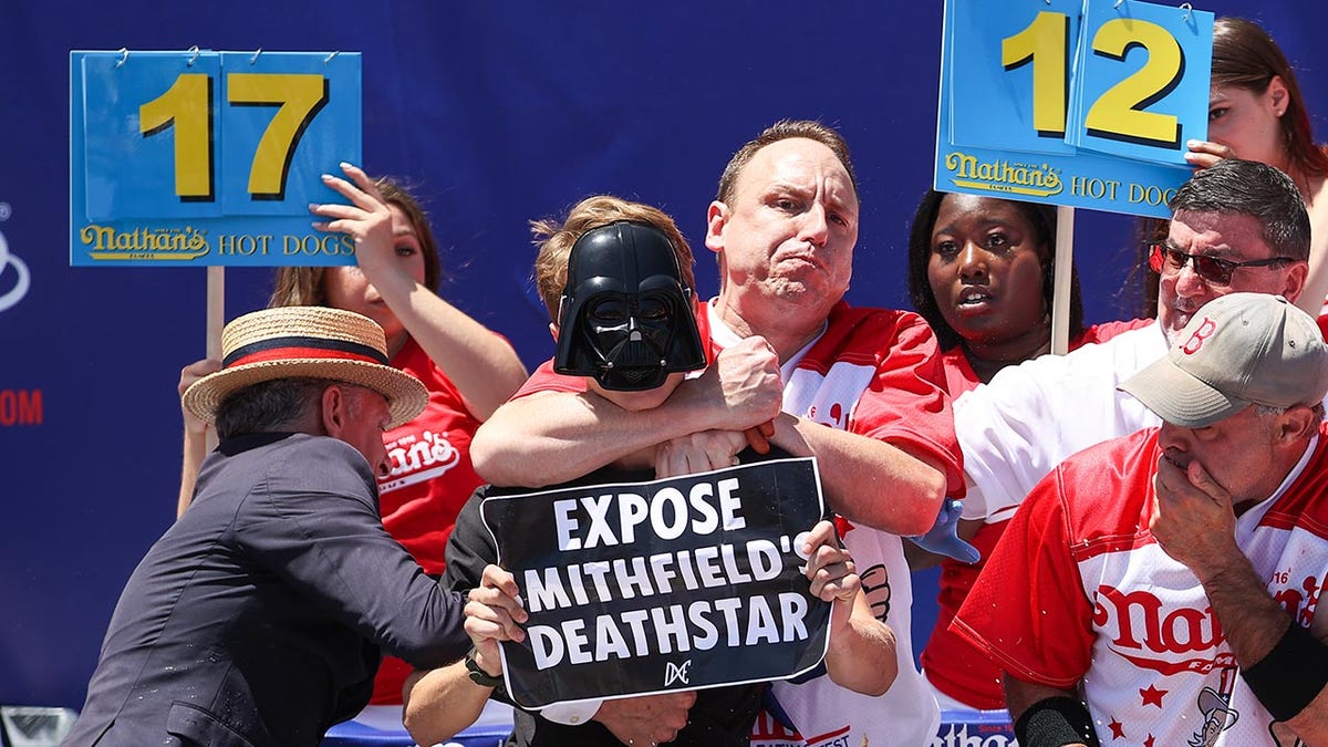 Joey Chestnut with protester