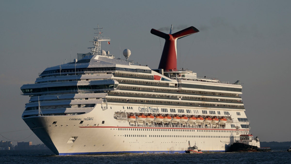 poop cruise ship Carnival Triumph is towed into Mobile Bay near Dauphin Island, Ala. 