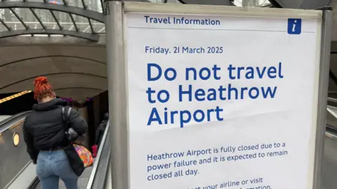 Reuters Sign at an underground station advising people not to travel to Heathrow Airport due to closure following a power failure 