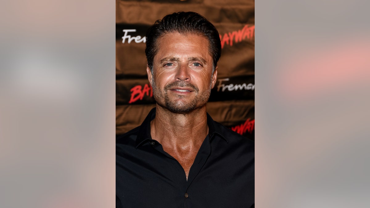 A close-up of David Charvet wearing a black shirt.