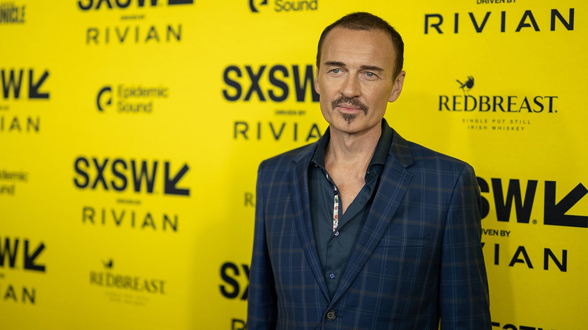 Julian McMahon wearing a dark blue suit at SXSW.