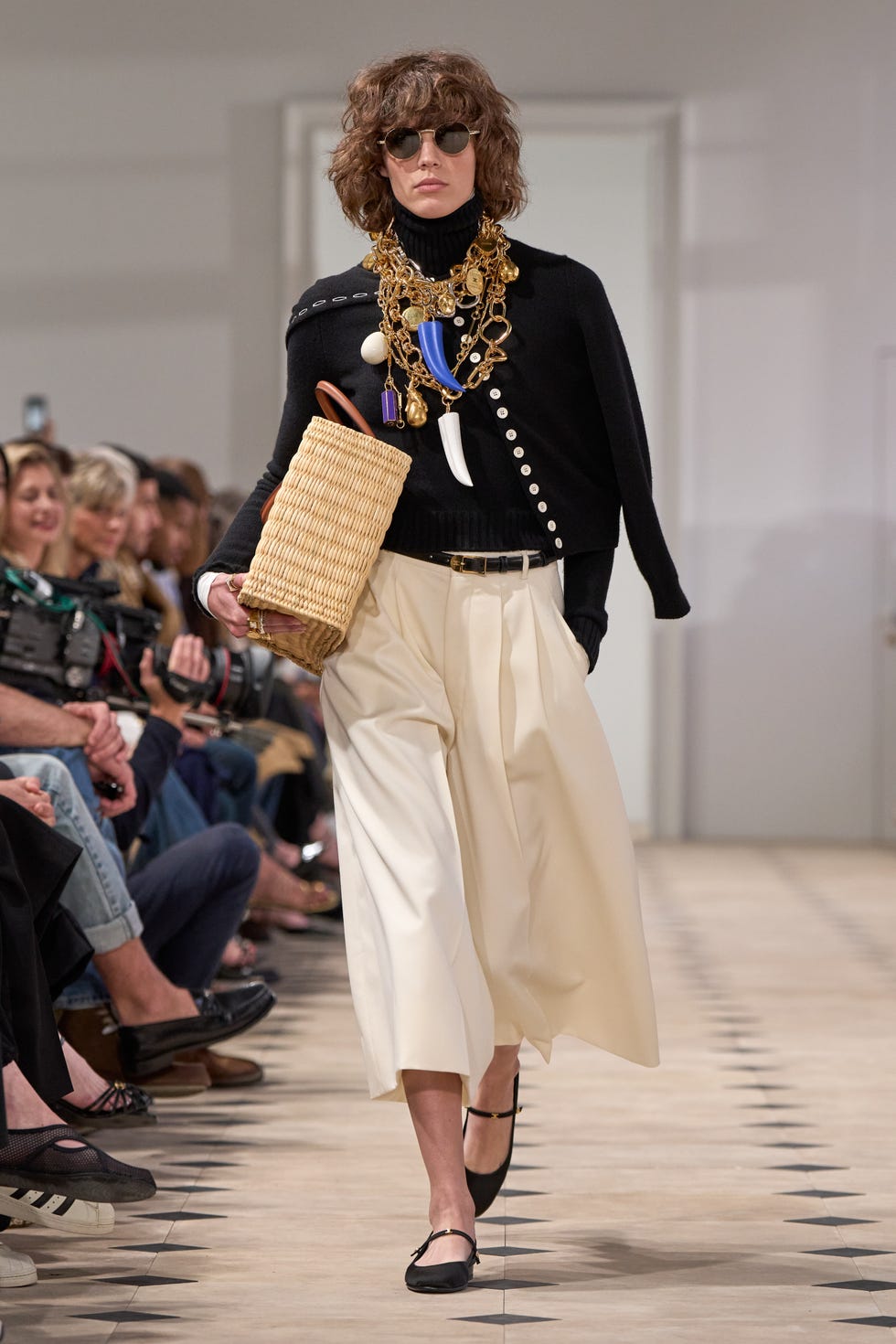 model showcasing a fashion outfit on a runway
