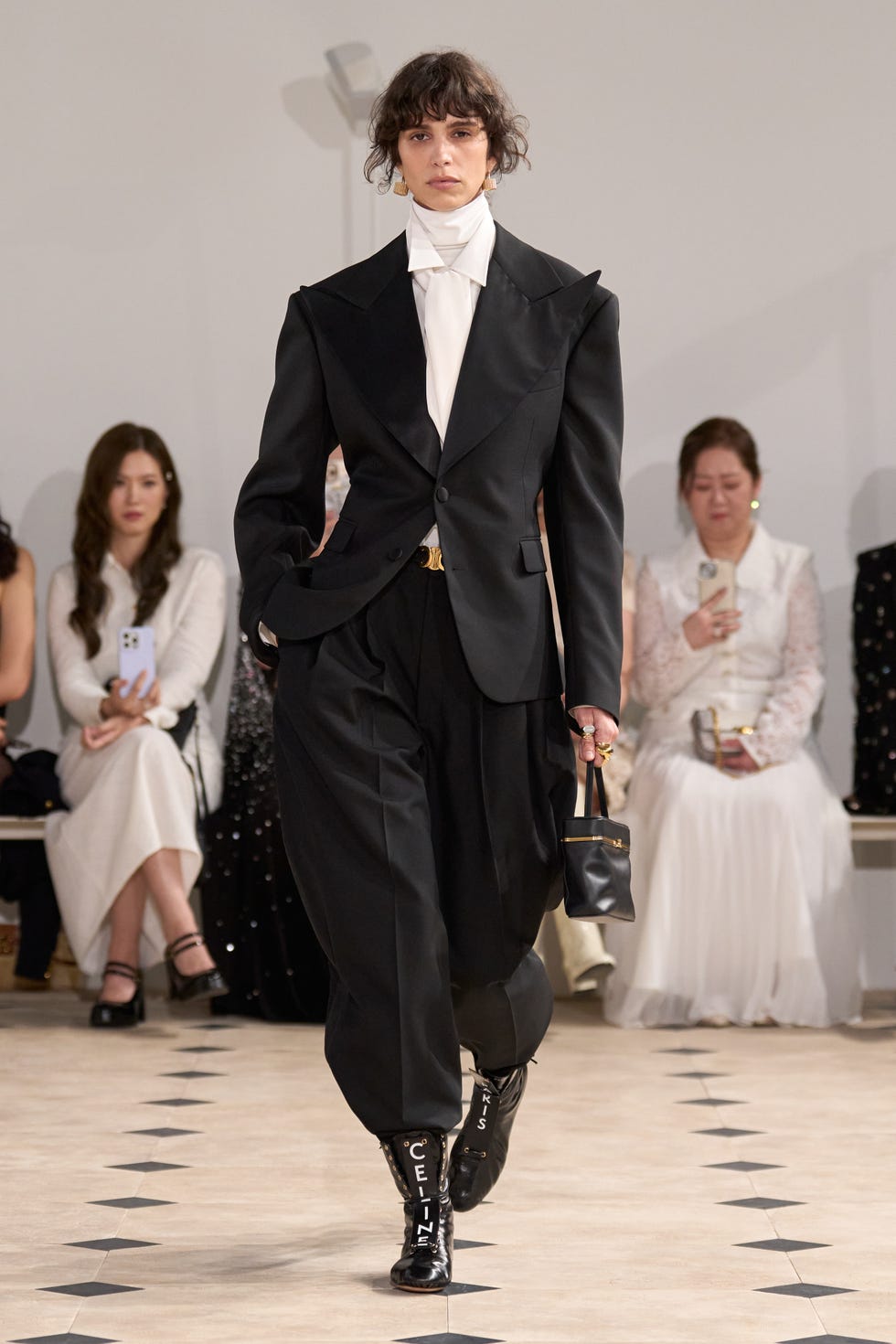 a model on a runway showcasing a fashion outfit