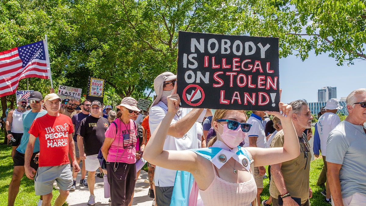 No Kings protests holding anti-ICE signs