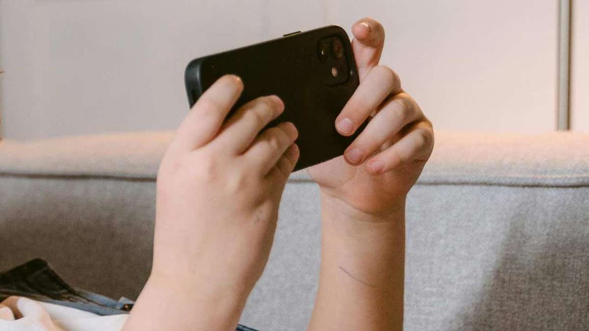 Illustration of a kid using Meta AI on his phone