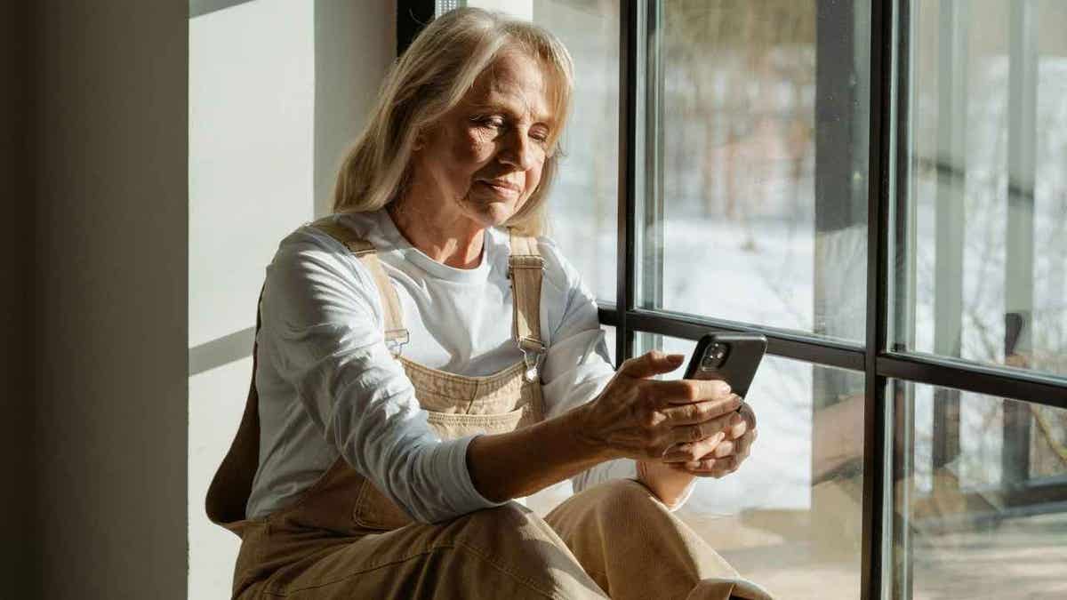 A woman scrolling on social media on her phone