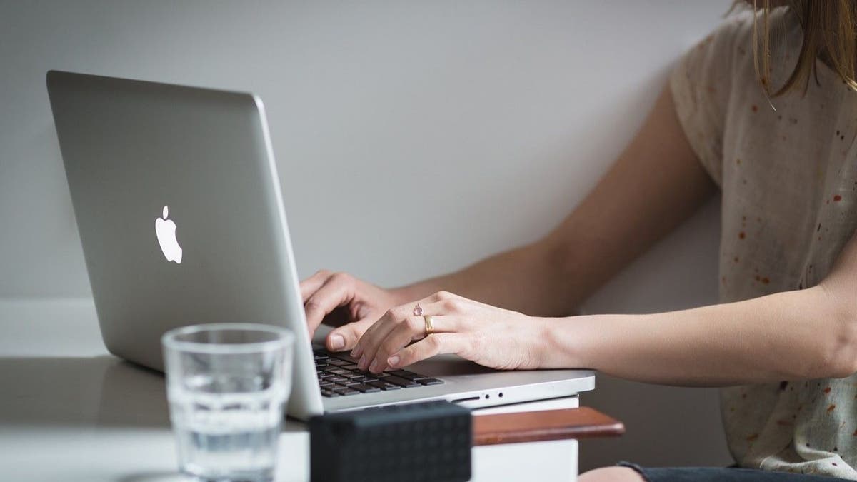 A woman checking her retirement accounts on her laptop