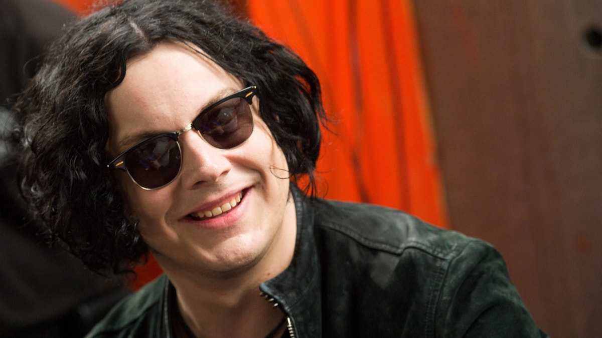 Jack White signs copies of the record he made with Stephen Colbert in New York.