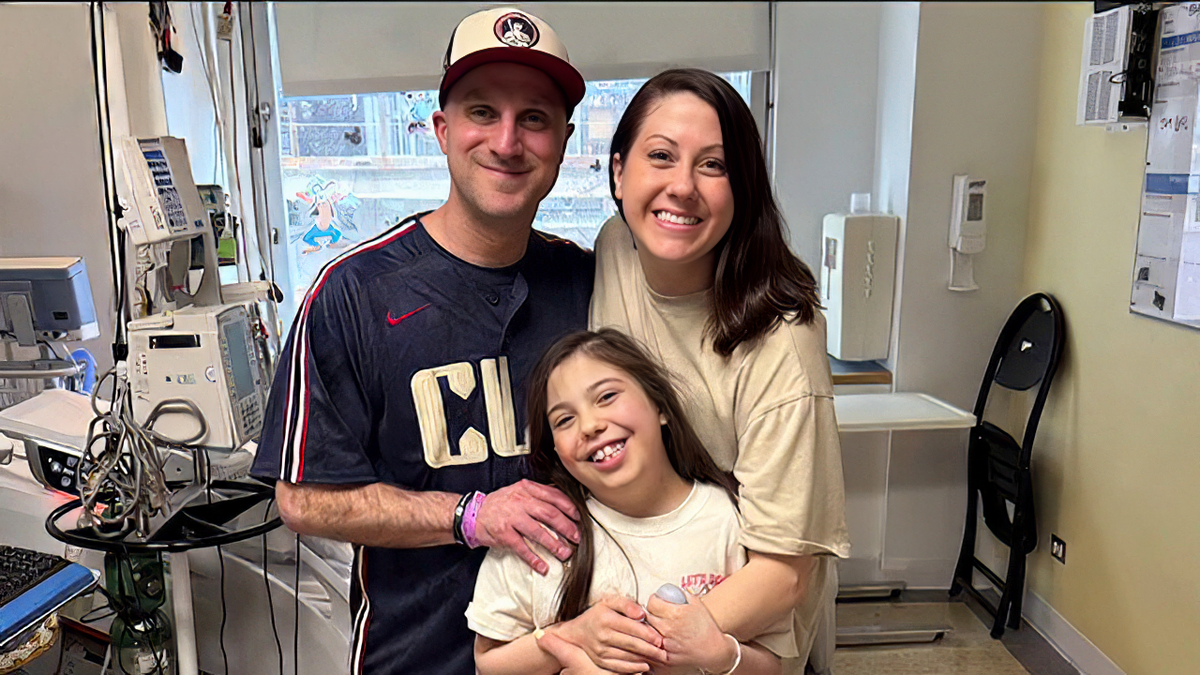 Heart transplant recipient Ava Cooper is pictured with her parents
