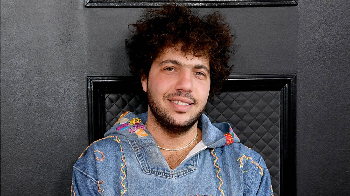 Benny Blanco walks red carpet wearing denim hoodie