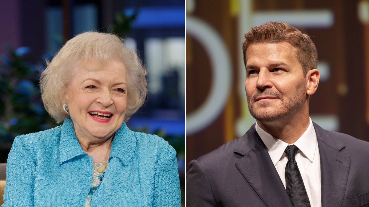 Betty White smiles wearing blue coat, David Boreanaz sports black suit.