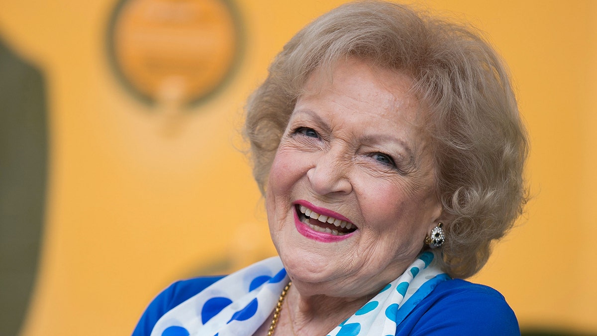 Betty White smiles in blue blouse