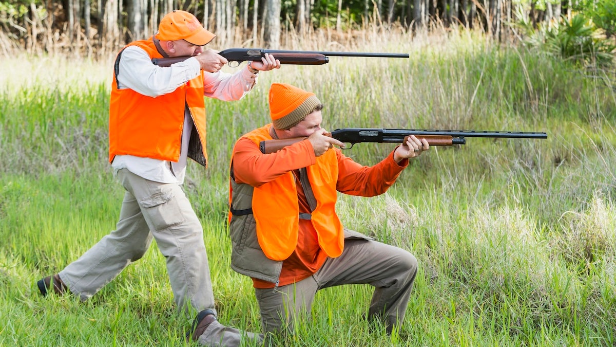 men hunting in orange vests